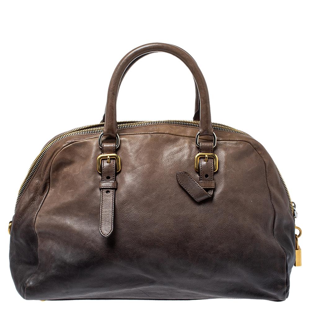 This top-notch and stylish satchel by Prada will surely leave you spellbound with its simple designs. Crafted from leather, the bag features the logo plaque at the front and an ombre effect. With dual-rolled handles and gold-tone hardware, the