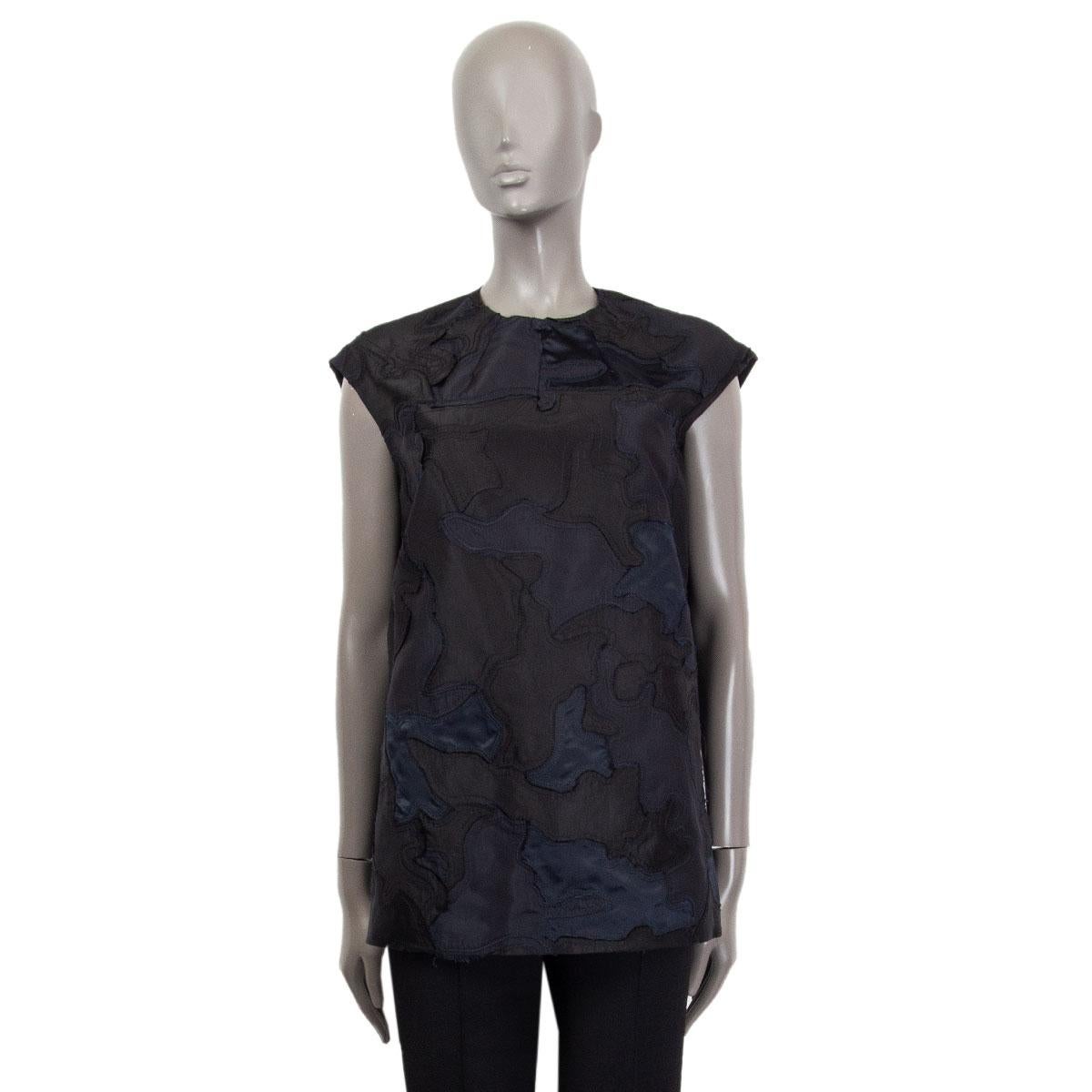 100% authentic Prada oversized sleeveless blouse in black and midnight blue in camouflage patchwork style silk (100%), wool (52%), silk (48%). Lined in black silk (56%) and polyester (44%). Keyhole detail on the back. Has been worn and is in