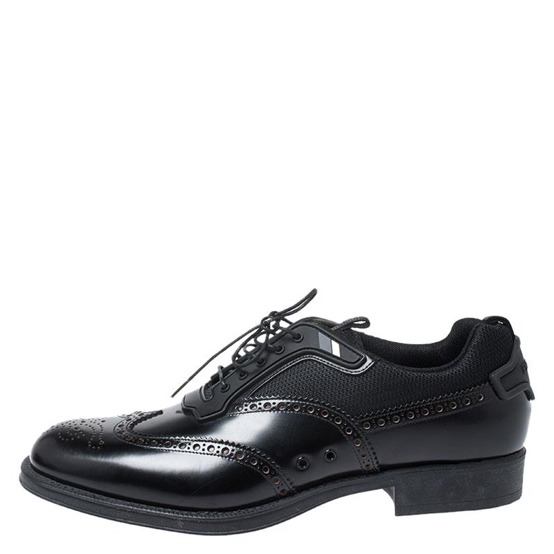 How can one not be in awe by just looking at this luxe pair from Prada! These leather and mesh Derby sneakers are well-crafted and come in a classic black color. They are beautified with lace-ups and brogue detailing. The counters feature the brand