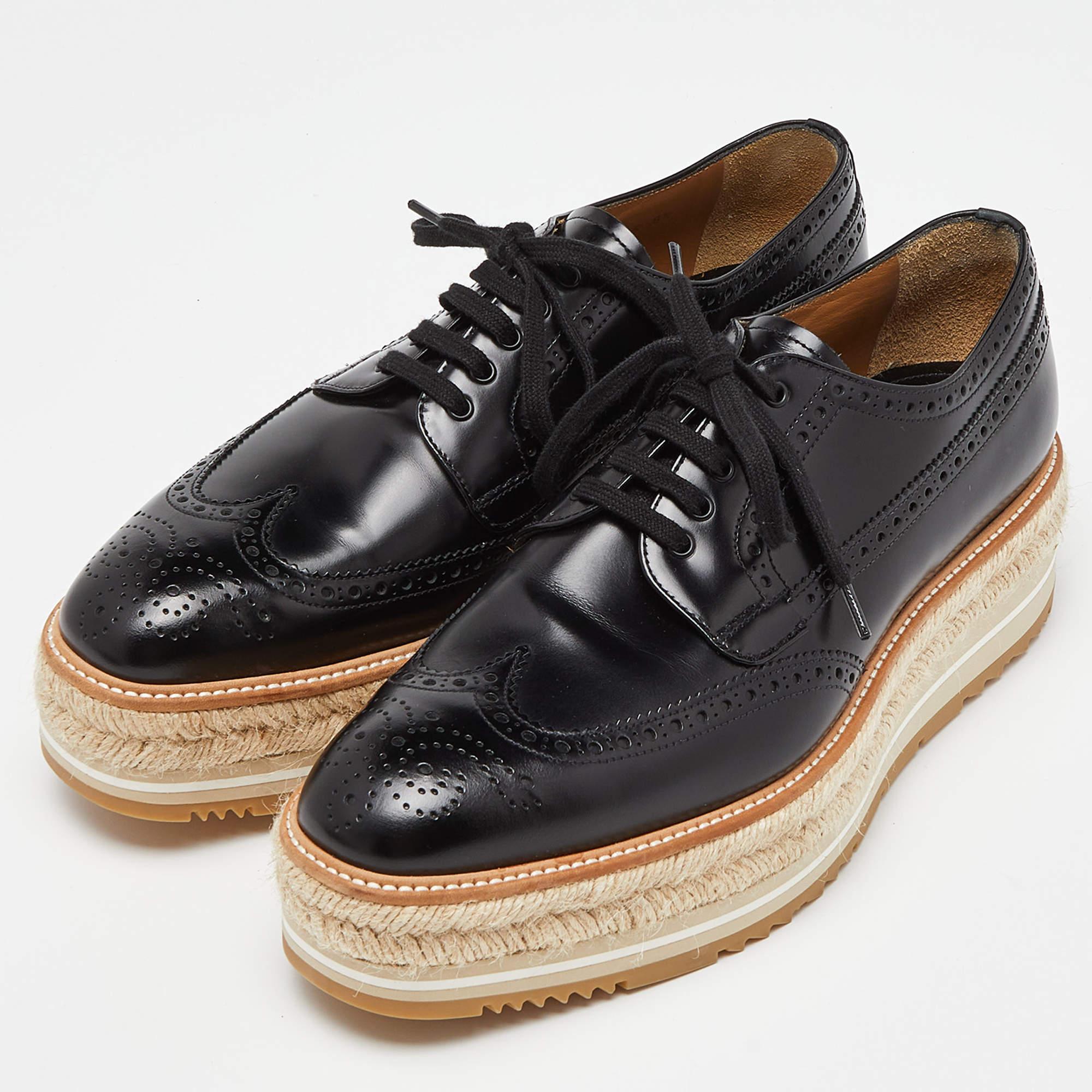These sneakers are not just stylish, but also comfortable and easy to wear. This black pair of Prada espadrilles will accompany a casual outfit with perfection. They are made of brogue leather and detailed with laces and espadrille detailing.

