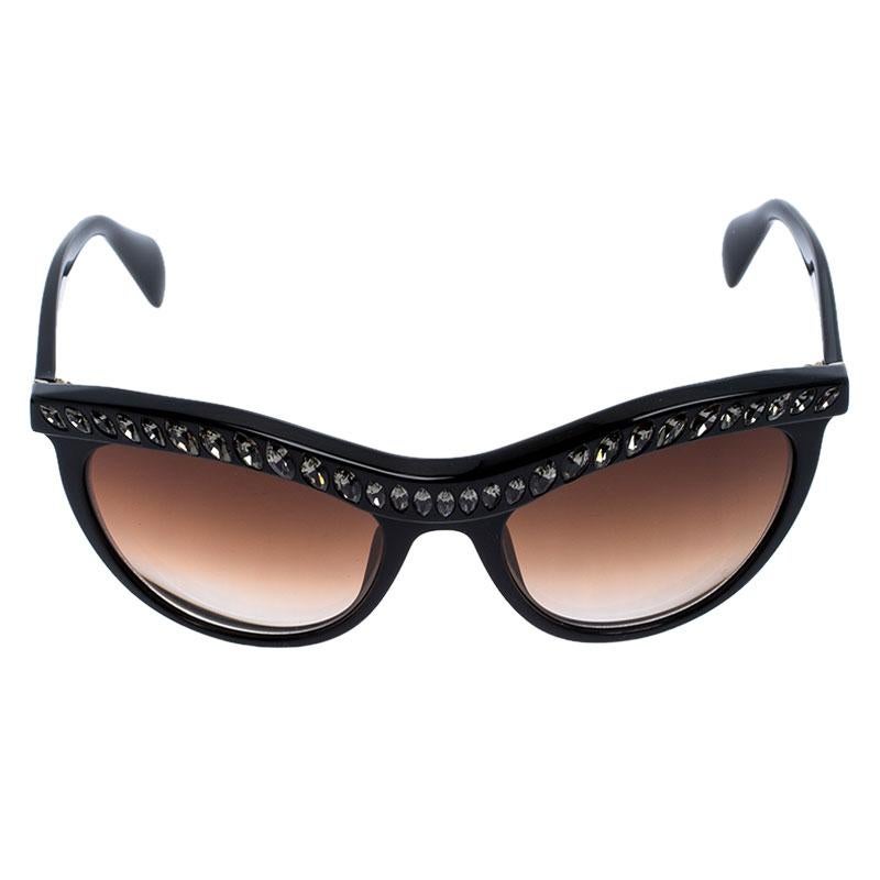 This pair of sunglasses from Prada is in tune with the high-end, grand style the brand is known for. The gradient lenses that are made in Italy come enclosed in cat-eye frames enhanced with crystals on the front and the brand name on the