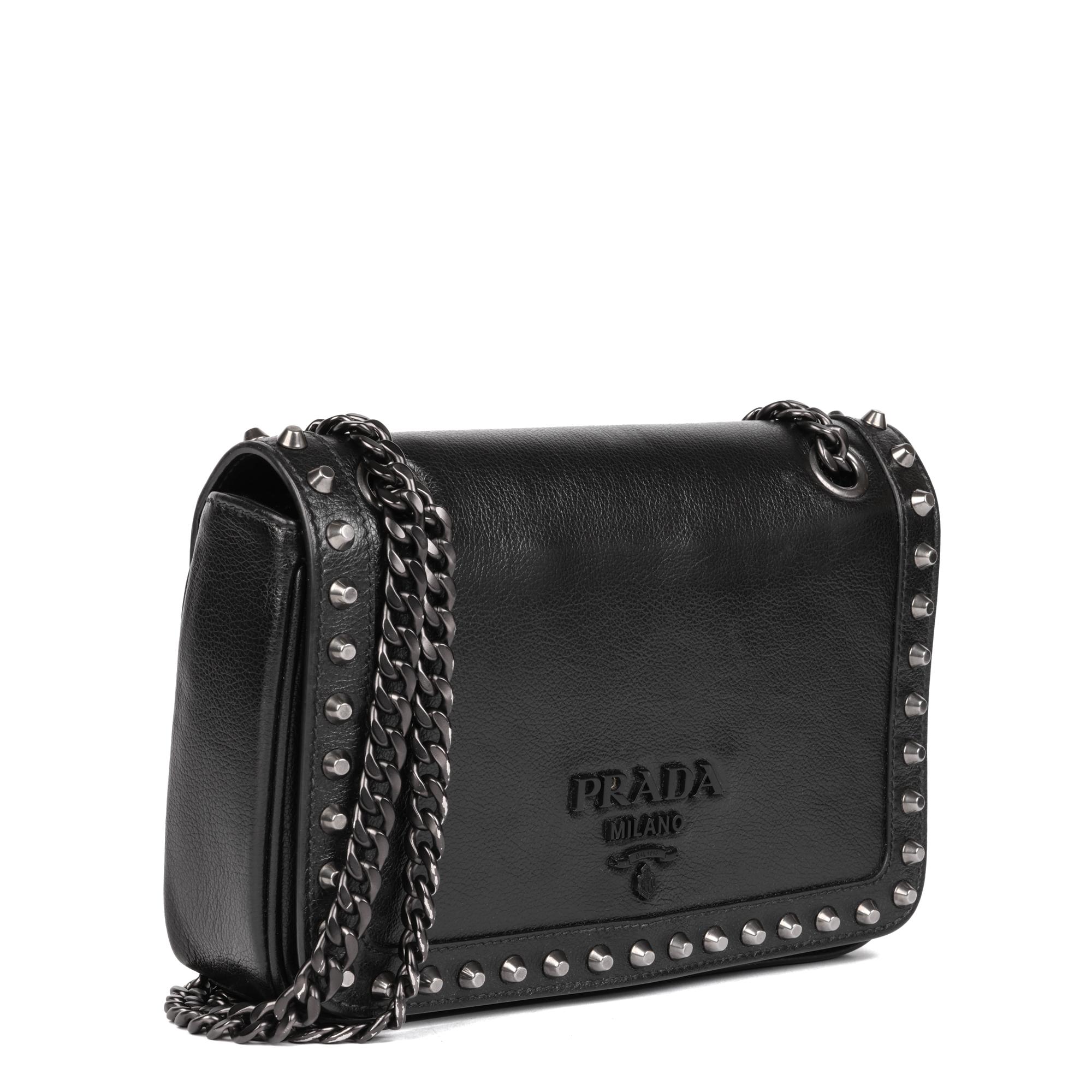 PRADA
Black Calfskin Leather Studded Crossbody Bag

Serial Number: 59
Age (Circa): 2010
Authenticity Details: Serial Tag (Made in Italy) 
Gender: Ladies
Type: Shoulder, Crossbody

Colour: Black
Hardware: Silver
Material(s): Calfskin