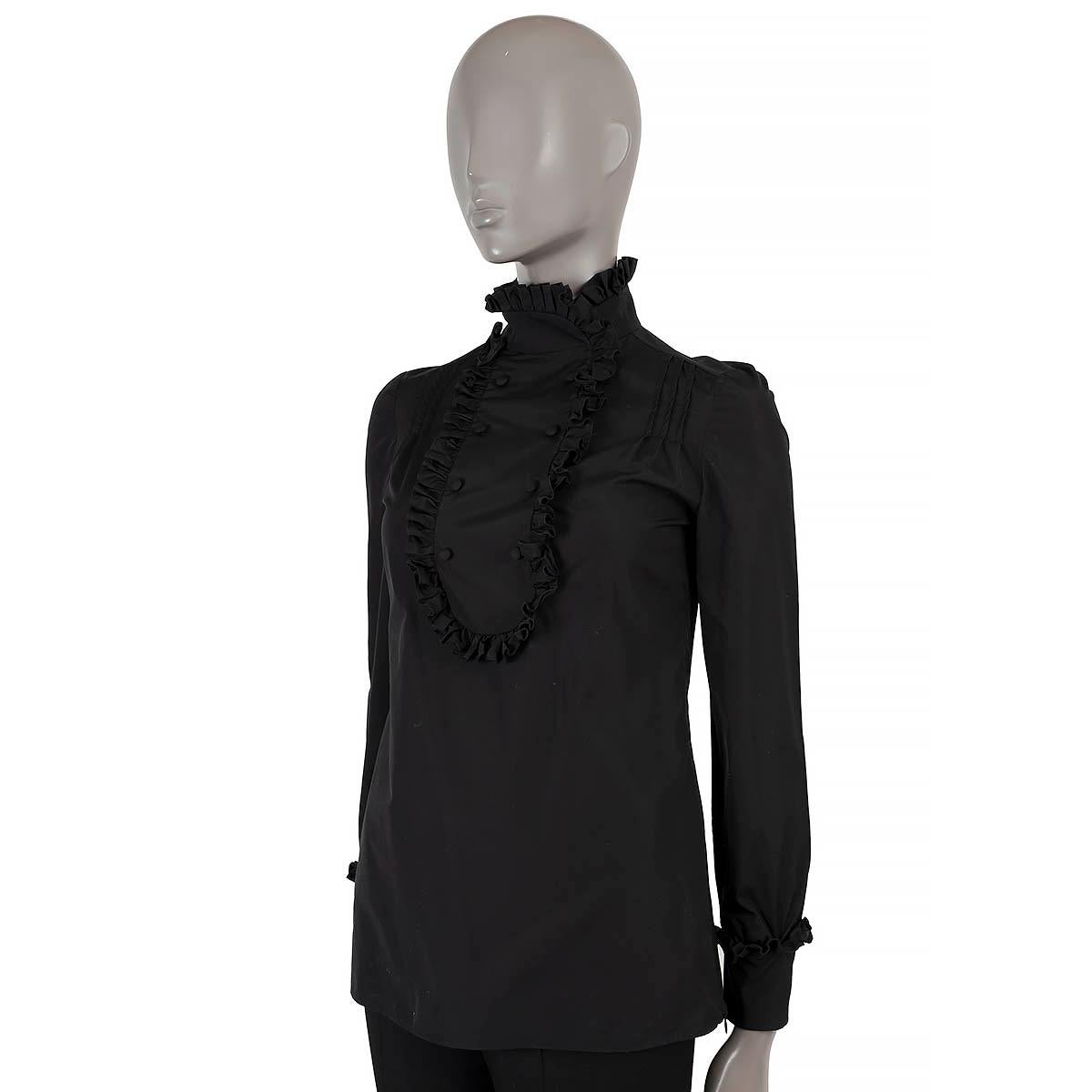 100% authentic Prada blouse in black cotton (100%). Features a high-neck, bib and ruffle trim and a zipper on the side. Has been worn and is in excellent condition.

2020 Pre-Fall
Measurements


Tag Size	38
Size	XS
Shoulder Width	36cm (14in)
Bust