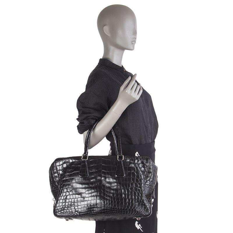 Prada 'Large Top Handle' bag in black crocodile. Closes with a zipper on top. Lined in black leather with a zipper pocket against the front and back. Has been carried and is in excellent condition. Retails for CHF 26'000.

Height 27cm (10.5in)
Width