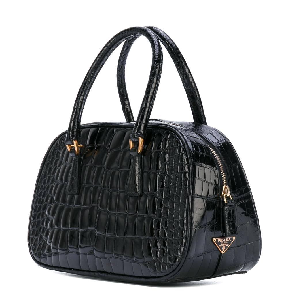 Eelegant Prada black crocodile leather small handbag. It features round top handles, a top zip closure and an internal zipped pocket. The item is vintage, it was produced in the 2000s and is in very good conditions. 
Width: 23 cm
Height: 14
