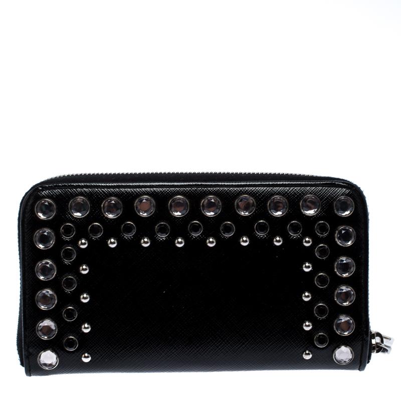Durable and long-lasting, this wallet is crafted from fine quality leather. Suave and stylish, this wallet from Prada effortlessly fits in your essentials. A statement-making black shade and studs all over the front make this bag super