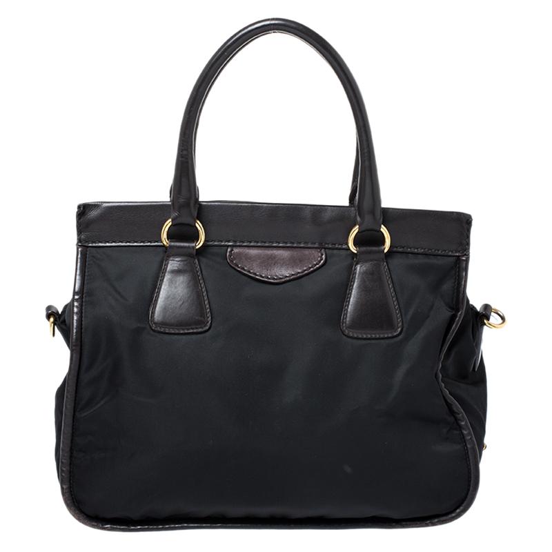 A perfect addition to your wardrobe will be this black tote from Prada. Crafted from nylon and enhanced with leather the tote features dual handles and a shoulder strap. The interior is well-sized and has a zip pocket.

Includes: Original Dustbag,