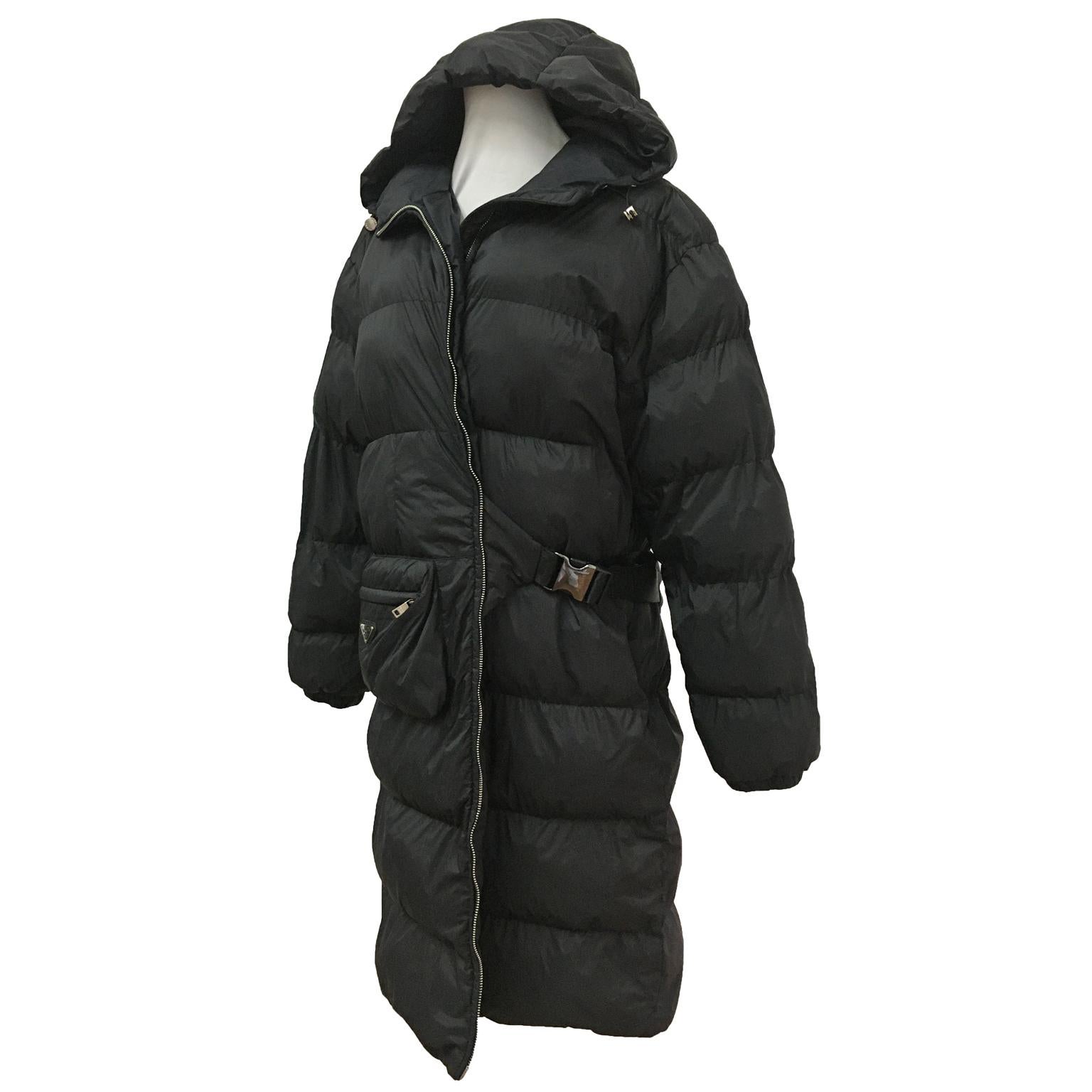Prada black nylon goose down padding coat with hood. Features an original pouch pocket on the front. 
It has kimono-like closure, with side-release buckle, and the metal triangle logo. 
Made in Italy 

Size : M

Measurements ; 
Length from neck
