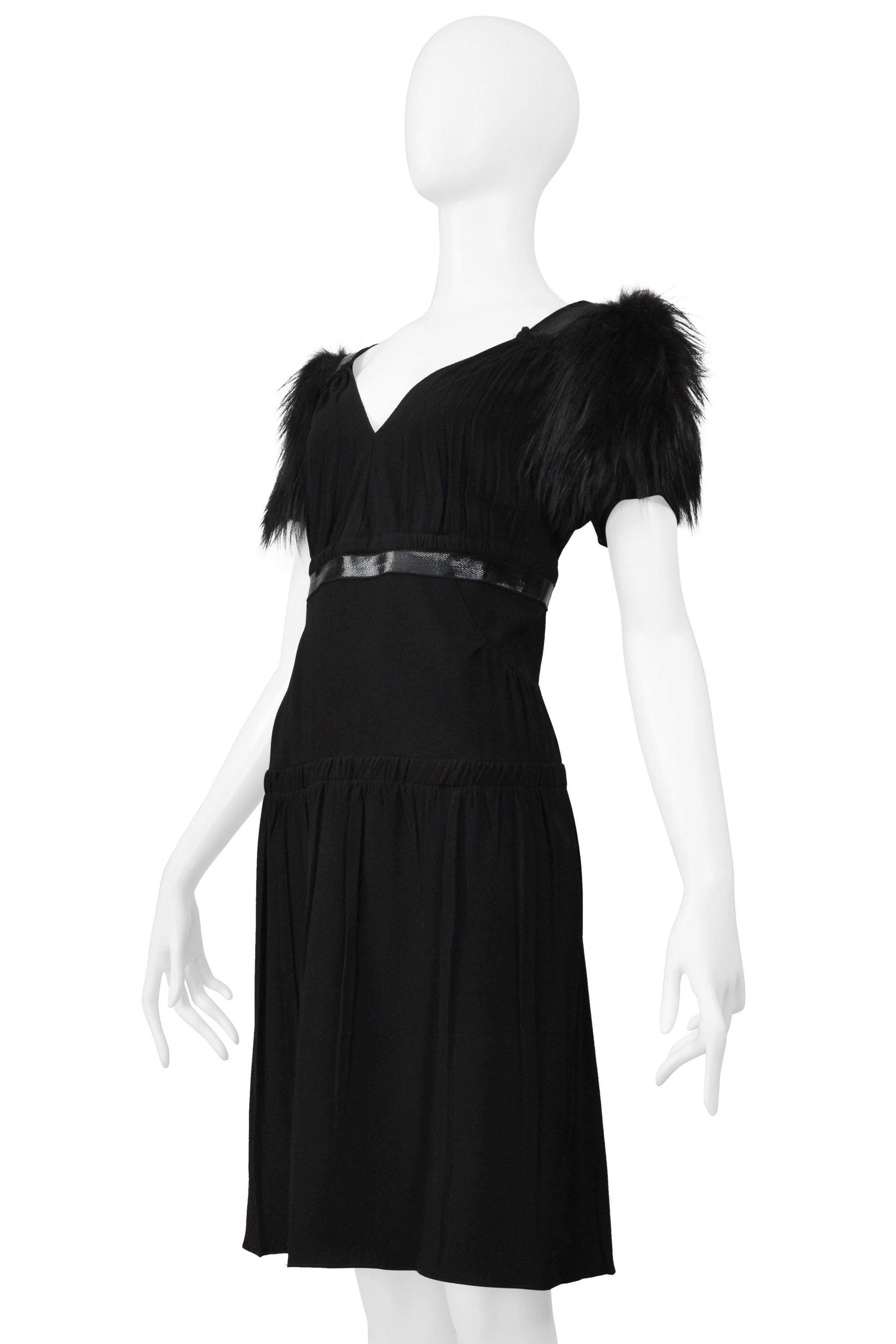 Resurrection Vintage is excited to offer a vintage Prada black mini dress featuring an empire waist with a leather band, front and back V-neckline, gathers at the bodice and skirt, knit sleeves with fur poufs, center back zipper, and above-the-knee