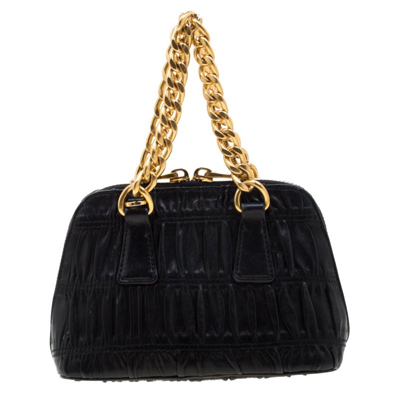 This stunning Promenade bag is high on appeal and style. Dazzling in a classy black shade, the bag is crafted from Gaufre leather and features chain handles. The double zip closure leads way to a leather interior with enough space for your little