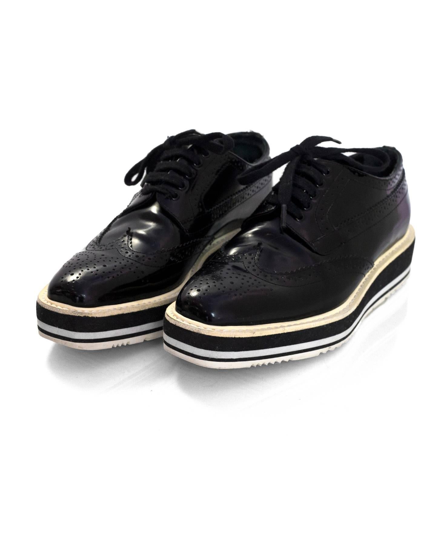 Prada Black Glazed Leather Brogues Platform Oxford Sz 38

Made In: Italy
Color: Black, white
Materials: Glazed leather, rubber
Closure/Opening: Lace tie closure
Sole Stamp: Prada 38
Overall Condition: Very good pre-owned condition with the exception