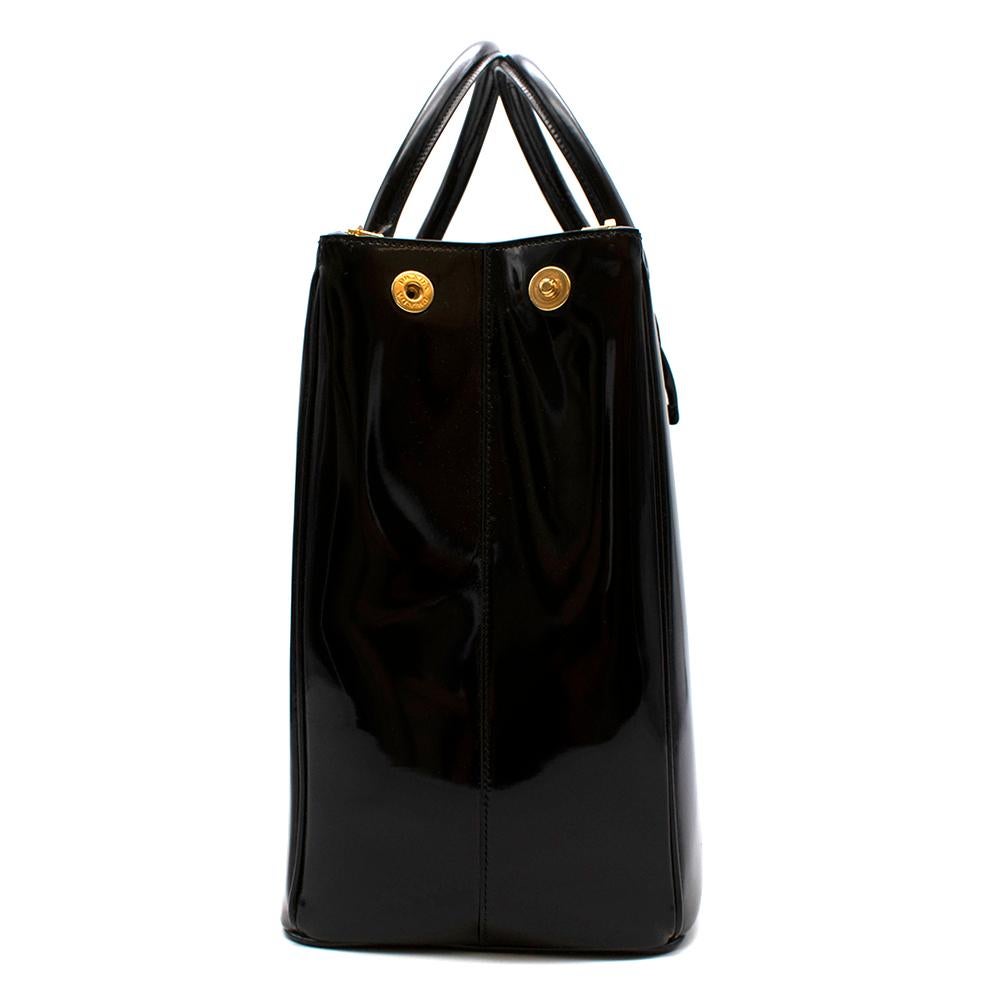 Prada Large Galleria Bag

- Shiny semi-patent finish to the bag
- Gold hardware on the zips and around the logo
- Two zipped compartments with a large middle open space
- Prada logo black canvas
- Clips on each side to close the bag for security
-