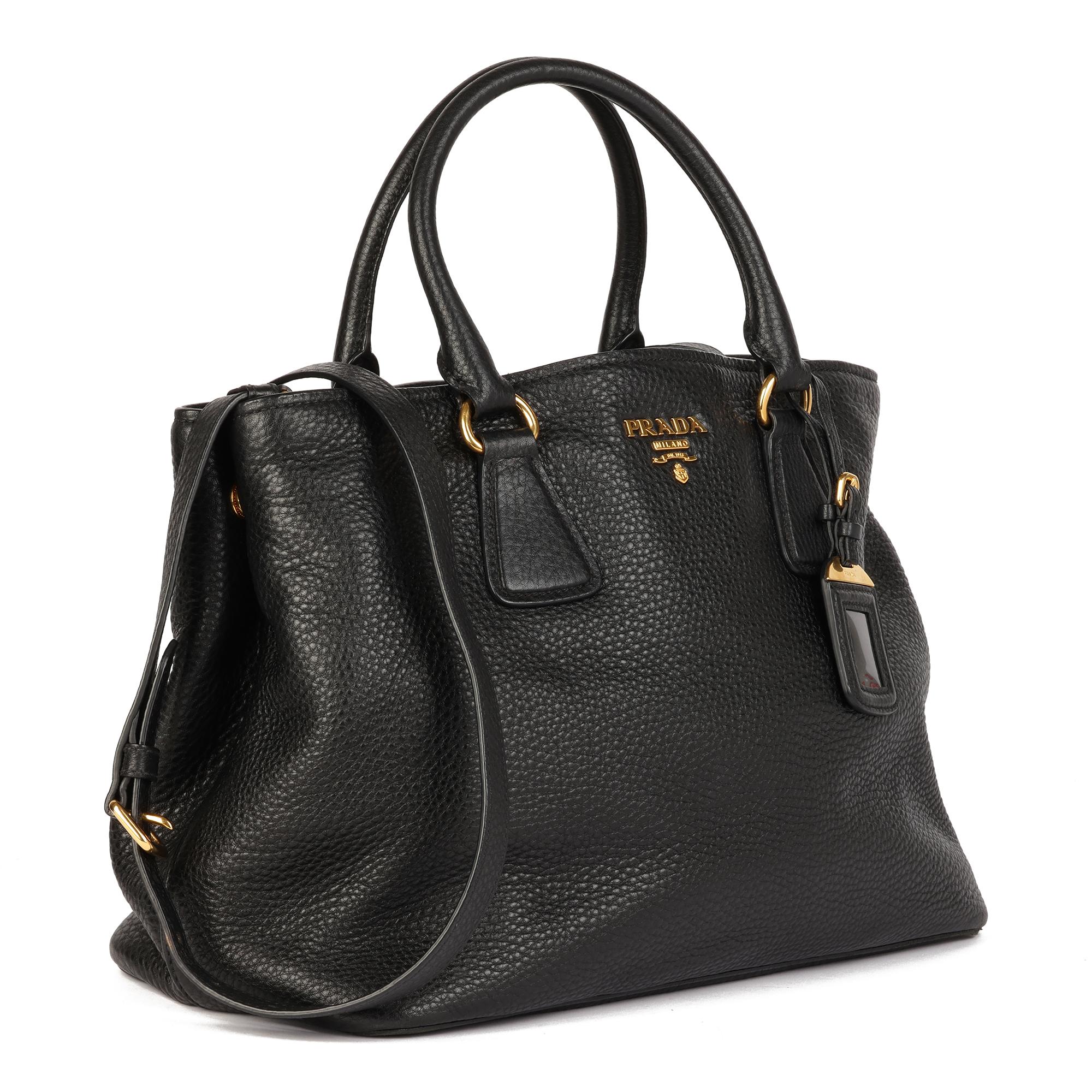 PRADA
Black Grained Calfskin Leather Vitello Daino Tote 

Serial Number: 173
Age (Circa): 2012
Accompanied By: Shoulder Strap, Authenticity Card
Authenticity Details: Serial Tag (Made in Italy)
Gender: Ladies
Type: Tote, Shoulder, Crossbody

Colour: