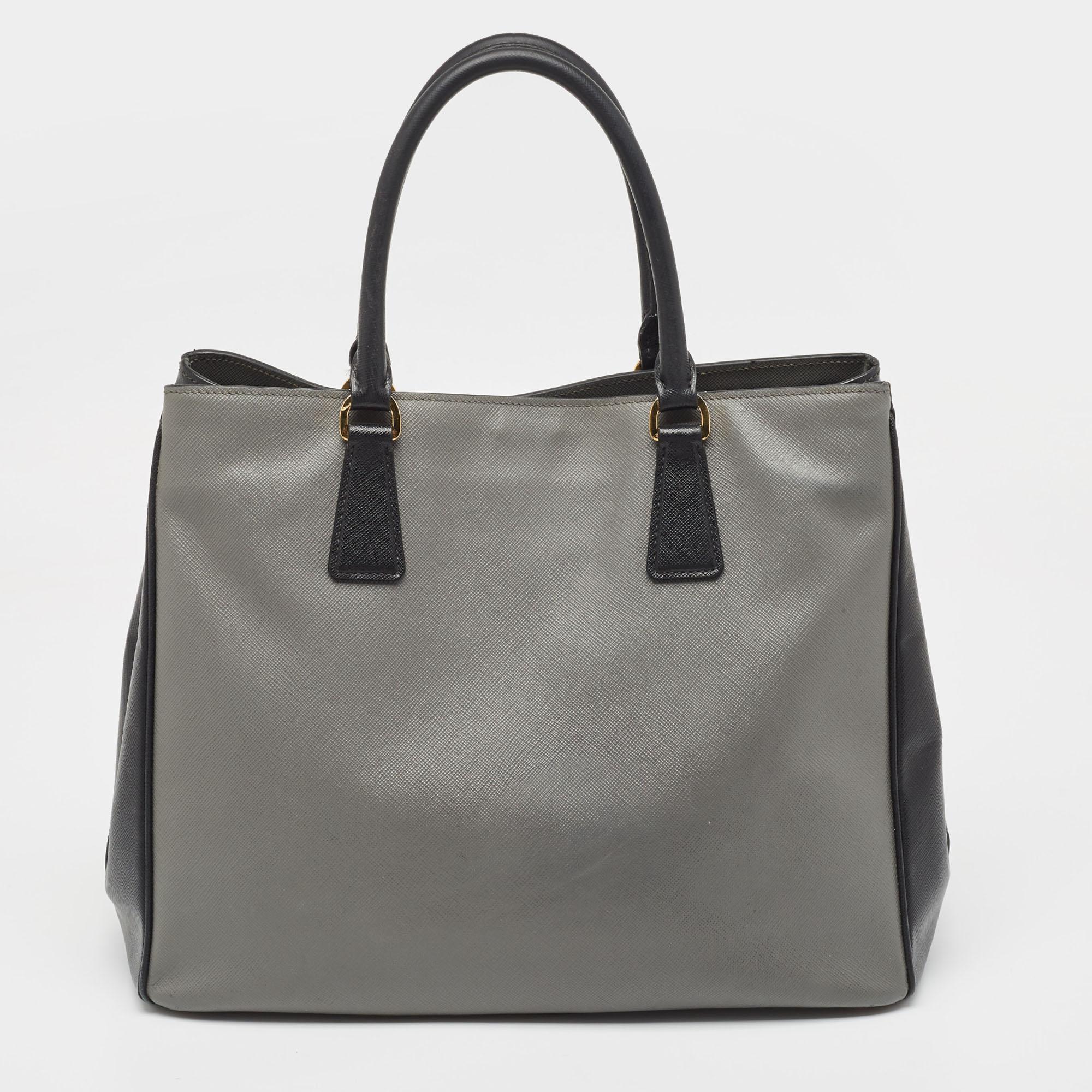 The architectural shape of this Prada tote makes it distinct and fashionable. Made from premium materials, it can be carried around conveniently and it is equipped with a perfectly-sized interior.

Includes: Detachable Strap