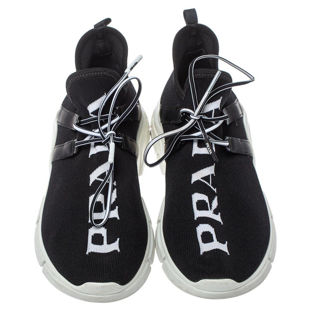 This pair of sneakers from Prada makes sure that you are in style every time you flaunt them. Designed from black knit fabric, these sneakers feature contrasting logo accent all over the vamps, lace-up fastenings, pull tabs at the rear, and sturdy