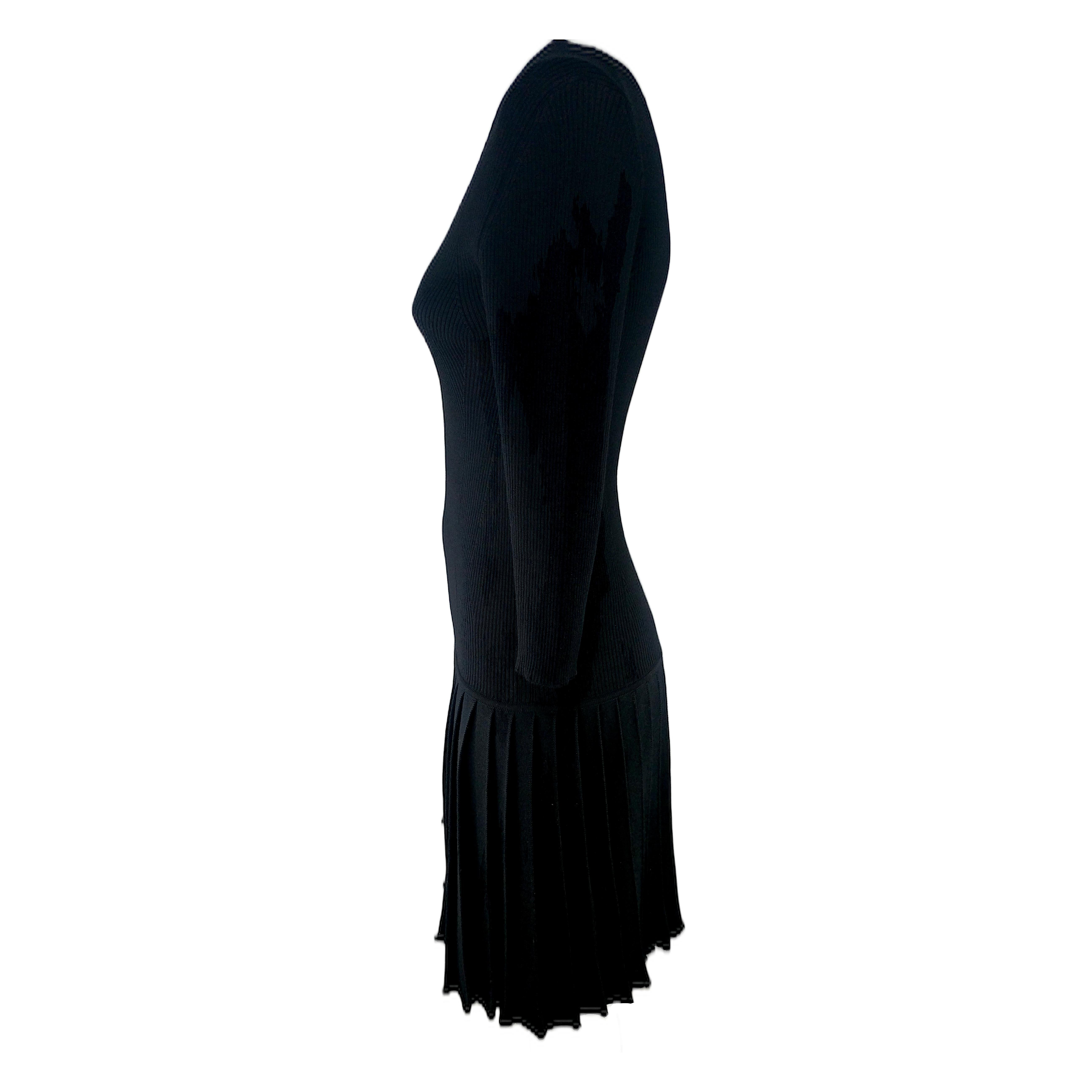 This genuine dress by Prada features a V-neckline, Three-Quarter sleeves and a pleated skirt. It is made of pure wool yarn and knitted in a way that makes it very stretch, thus accommodating various sizes. It's a very versatile item that you will