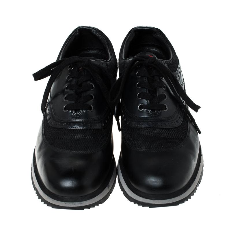 Built to last and add sophistication to any outfit, these leather and mesh sneakers are all you need. These Prada sneakers are accentuated with a timeless black hue, brogue detailing and a sturdy rubber sole that lends ultimate comfort.

