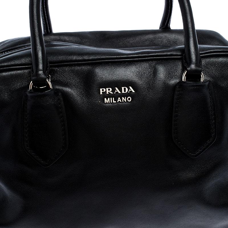 When you carry this Prada creation, be ready to catch admiring glances as this bag is stylish and handy. The bag has been crafted from leather in a lovely black shade and equipped with two top handles and a removable shoulder strap. The top zip