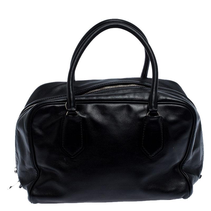 When you carry this Prada creation, be ready to catch admiring glances as this bag is stylish and handy. The bag has been crafted from leather in a lovely black shade and equipped with two top handles and a removable shoulder strap. The top zip