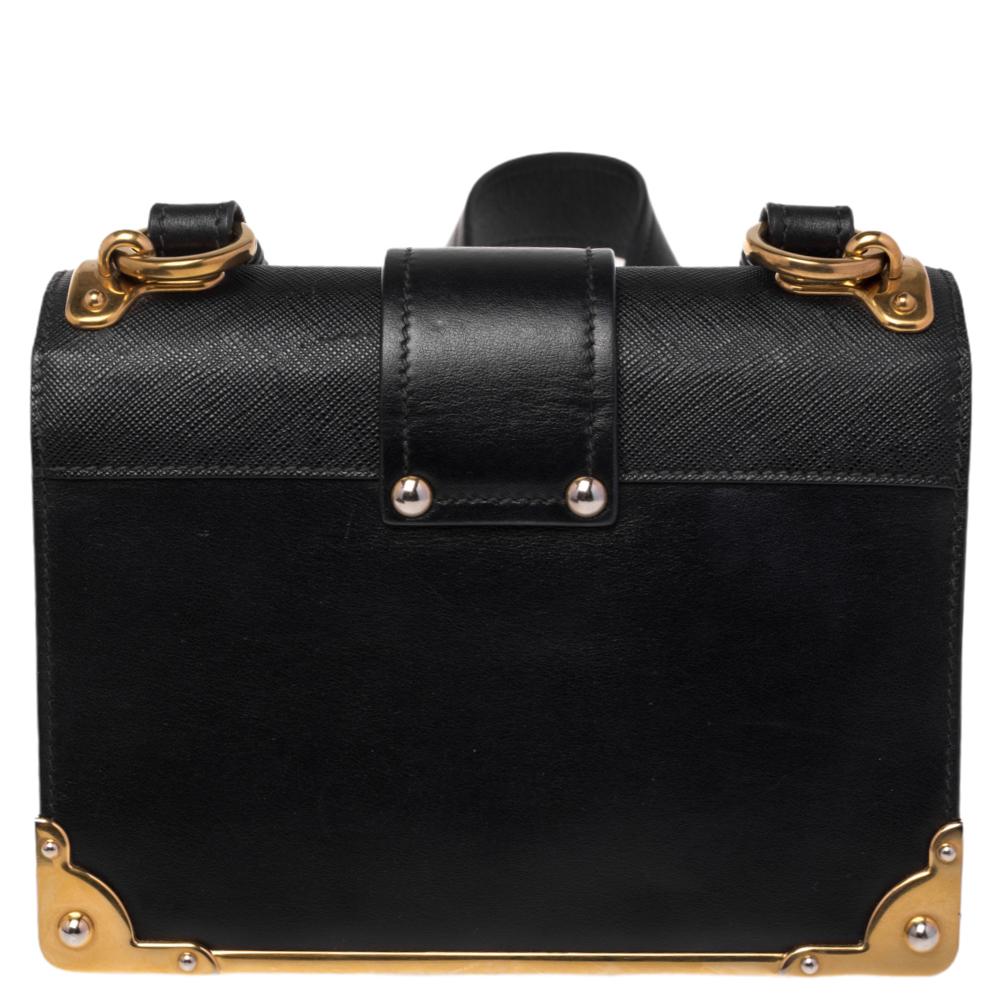 Inspired by valuable books from ancient times, the Prada Cahier bag is a best-seller. This shoulder bag is crafted in Italy with leather. It features a gold-tone tuck-in loop at the front that adds a touch of contrast. The strap with the brand logo