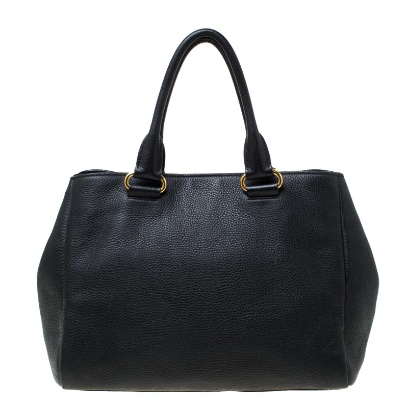Flaunt this stylish tote from Prada for an ideal look. The bag is crafted from black leather and features dual handles and a front zip pocket. The interior is nylon lined and very spacious. The bag will hold all your belongings with ease.

Includes: