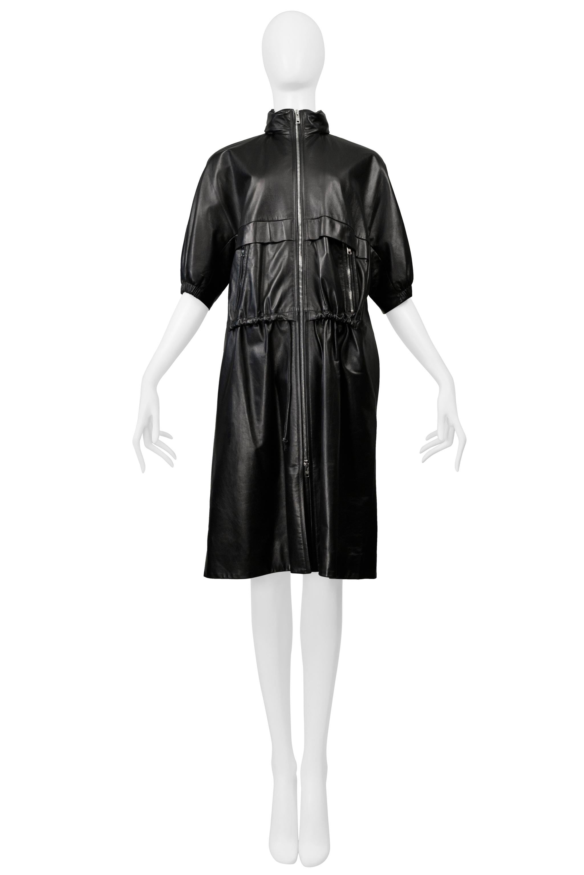 Resurrection Vintage is excited to offer a vintage Prada black lambskin leather Adirondack coat featuring silver zippers, drawstrings at the waist, front pockets, elbow-length sleeves, a hidden hood, and knee length. 

Prada, Italy
Size 36
Fabric