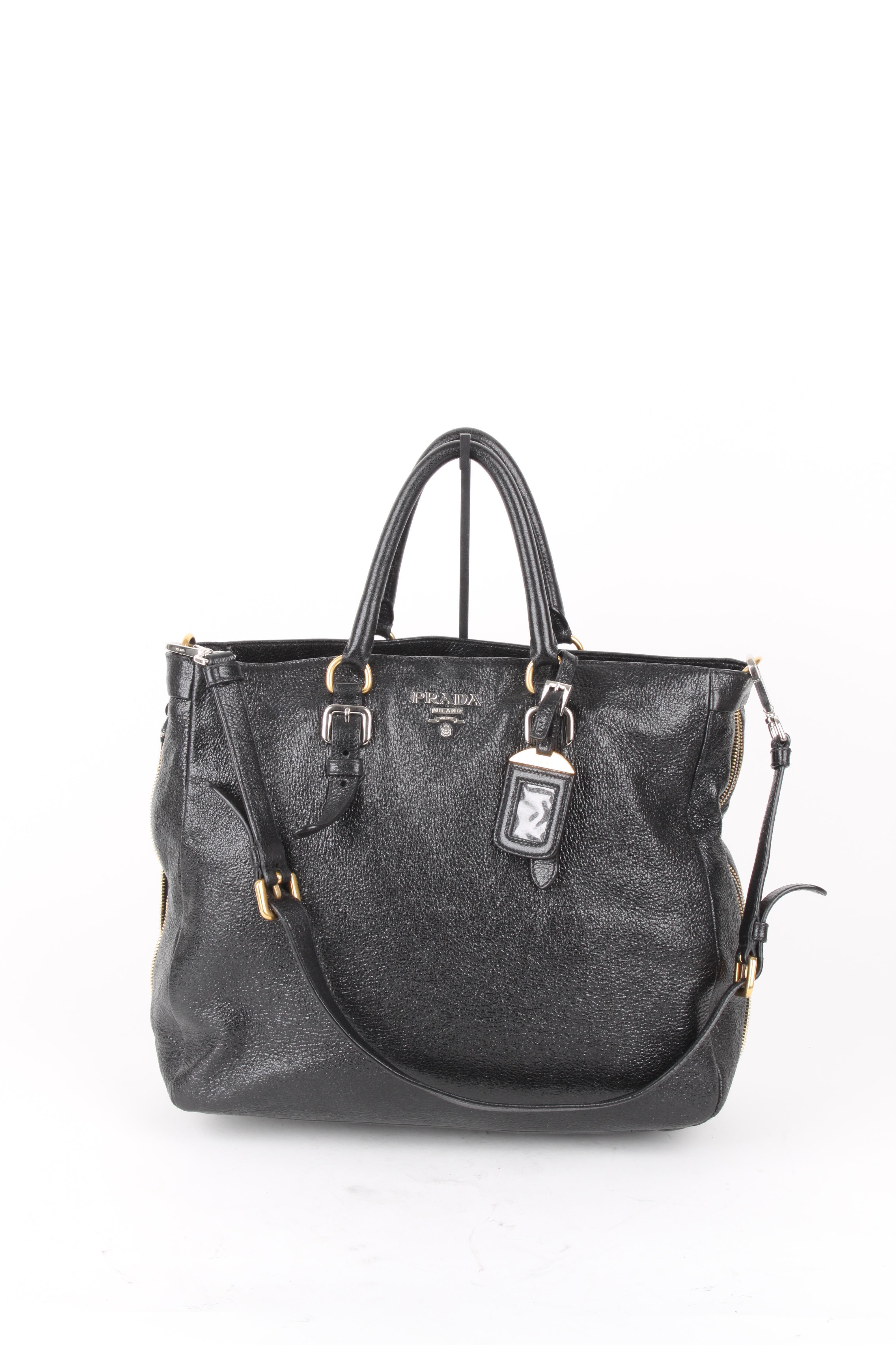 Prada Black Leather Crossbody Phenix Shopper Tote.

This little bag makes a big statement. It features a leather exterior with matching black leather handles. The bag features a black silk lining, zipper closure, one main compartment and two side