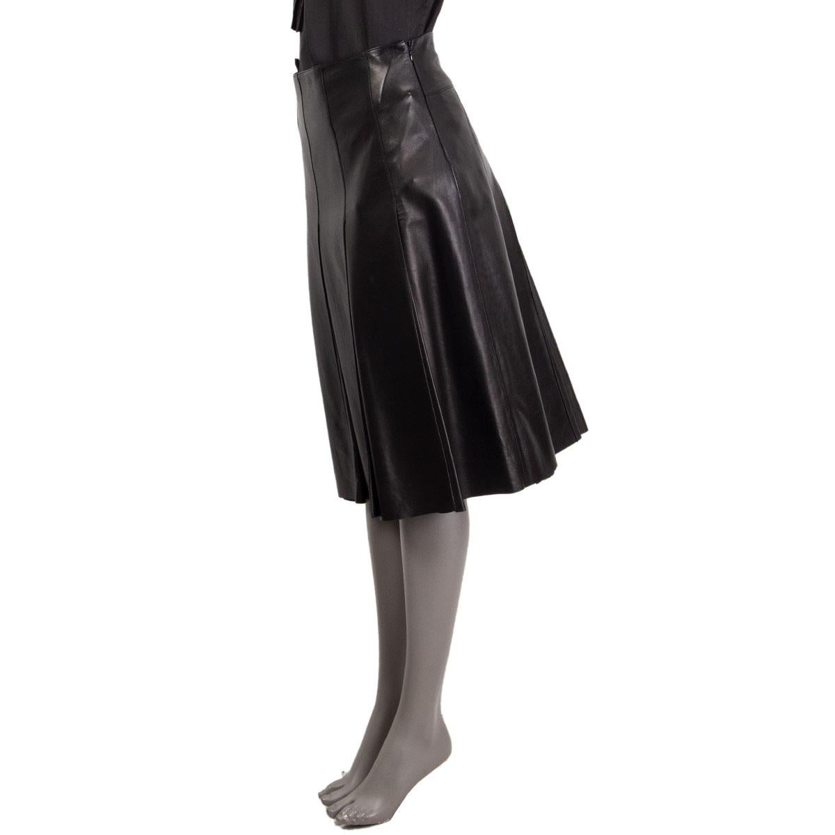 100% authentic Prada pleated skirt in black nappa leather (100%). Closes with a concealed zipper on the side and has a logo embossed buckle detail and a slit on the back waist-line. lined in black viscose (100%). Brand New with Tag.

Tag Size