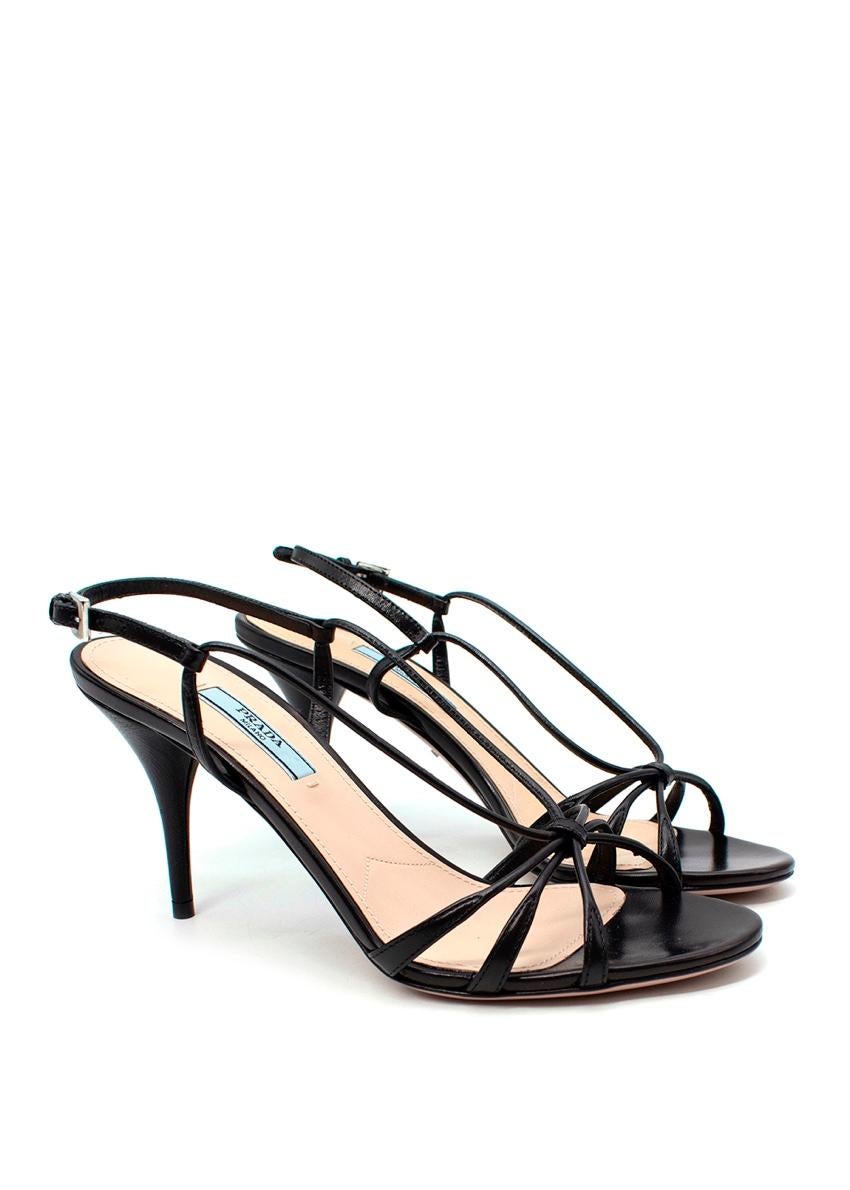 Prada Black Leather Knotted Strappy Slingback Heeled Sandals
 
 
 
 - Open, almond toe
 
 - Knotted leather straps
 
 - Silver-tone adjustable buckle slingback fastening
 
 - Set on a mid-height stiletto heel
 
 
 
 Materials 
 
 100% Leather 
 
 
