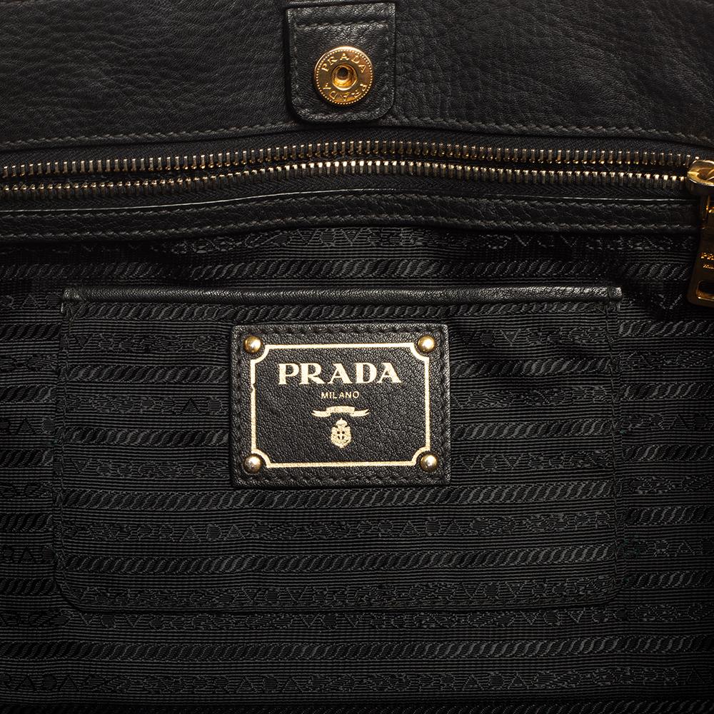 You can never go wrong with a black handbag, and this Prada tote is here to match every outfit of yours! It has an elegantly classic silhouette and comes with dual handles that open into a spacious interior to hold your essentials with ease.

