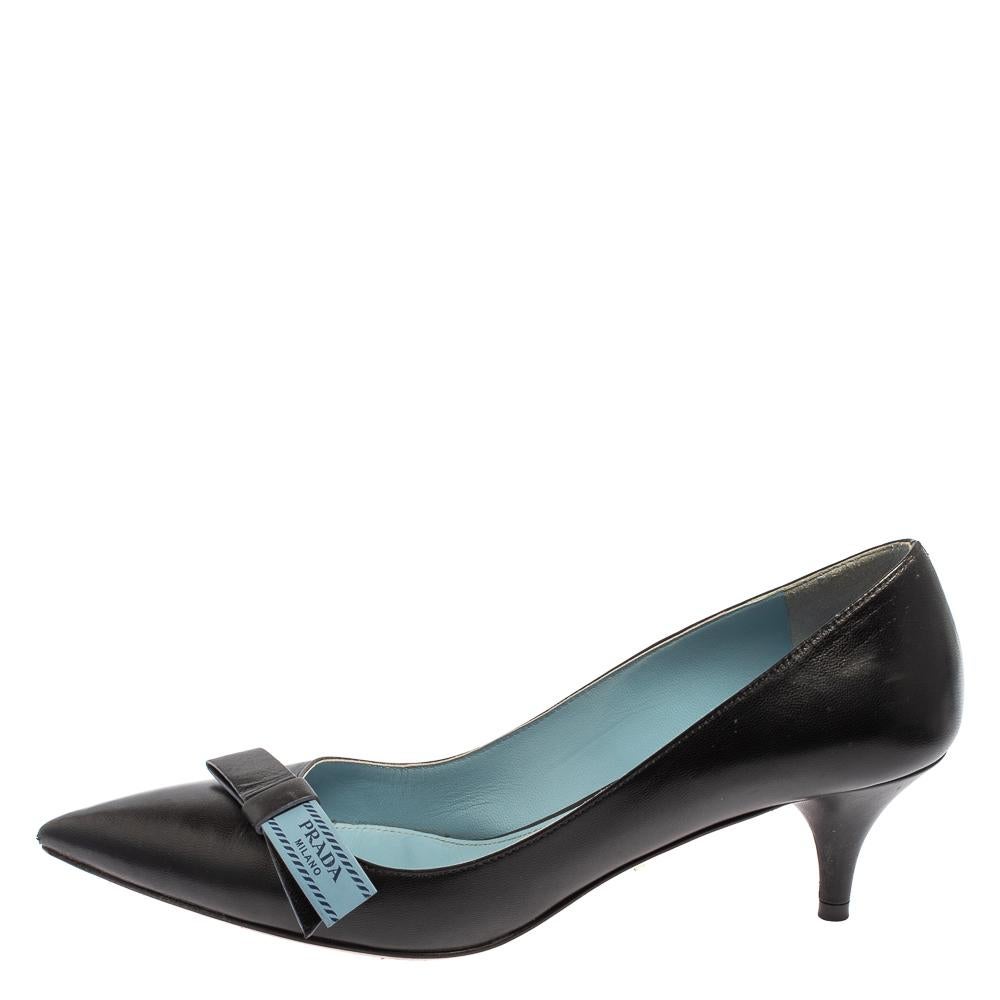 Every wardrobe deserves a classic pair of pumps and what better than these splendid ones from Prada! The black pumps are crafted from leather and styled with pointed toes and logo detailed bows on the vamps. They come equipped with comfortable