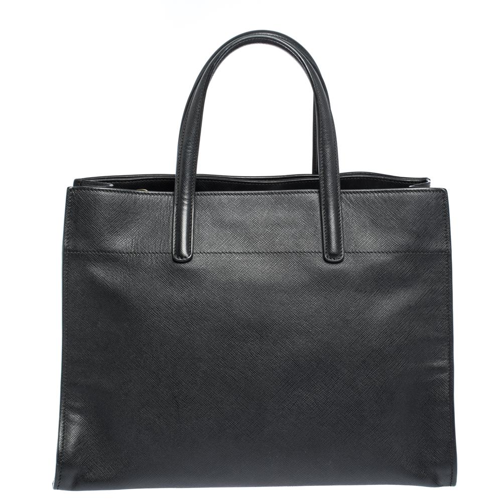 Handbags can transform any outfit, just like this classy tote from the house of Prada can. Crafted from quality leather and lined with nylon and leather on the insides, it features two flat handles, and a spacious interior divided by a zip
