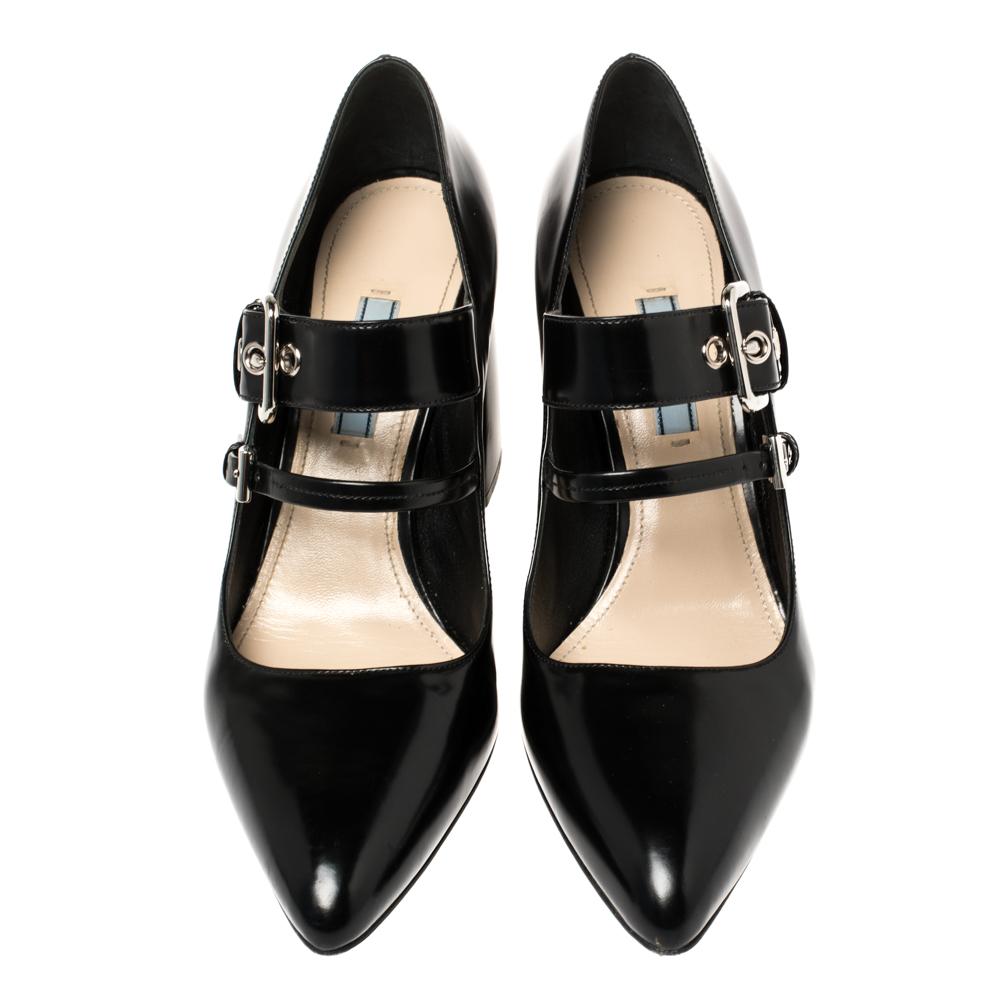 Amp up any outfit with these Prada Mary Jane Sylvie pumps. Crafted from leather in Italy, they feature dual buckle straps, pointed toes, and 9 cm block heels. The grand black shade adds to the appeal of the fashionable pair!

Includes: Original Box
