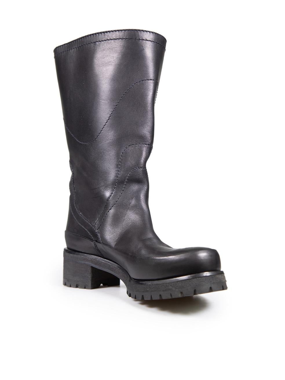 CONDITION is Very good. Minimal wear to the boots is evident. Abrasion to all areas of both shoes on this used Prada designer resale item.
 
 
 
 Details
 
 
 Black
 
 Leather
 
 Boots
 
 Mid calf
 
 Round toe
 
 Buckle detail
 
 Treaded soles
 
