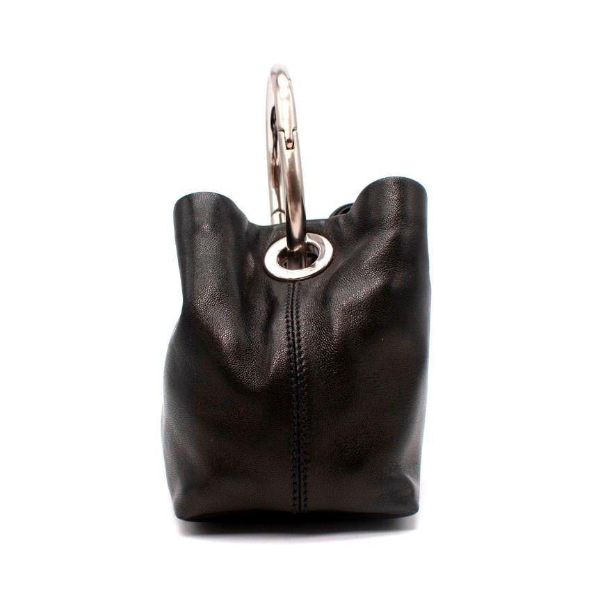 Prada Black Leather O-Ring Mini Top Handle Bag
 

 - Small sized, grab bag crafted from supple grained black leather, with silver-tone signature Prada logo plaque
 - Chunky silver-tone metal O-ring top handle with engraved Prada branding
 - Lined in