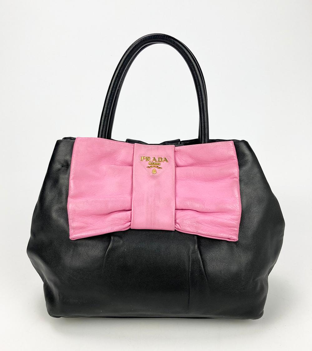very good condition. some wear on pink bow around hardware and edges. see photos. clean corners edges and interior. soft leather. measurements: 9x8x6