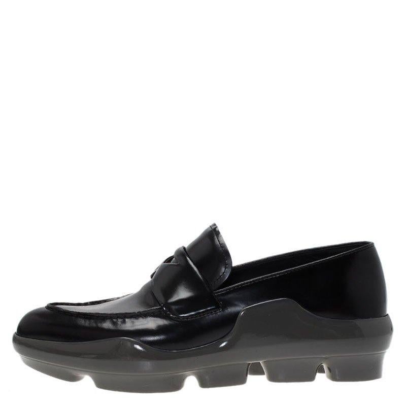 These black patent leather shoes from Prada have an extra thick sole forming the platform. The apron toe and boat opening adds to the comfort of wearing the shoes. The penny keeper strap at the vamp looks stylish.

Includes: Original Dustbag

