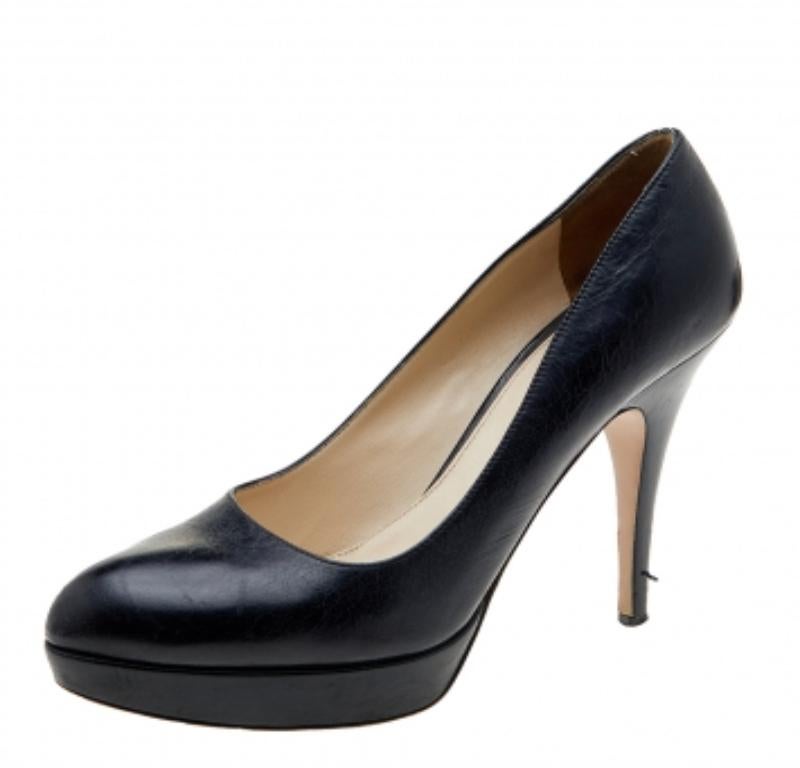 Estos zapatos de salón de la Casa Prada te ayudarán a dar cada paso con confianza, lujo y estilo. Están fabricados con cuero negro en el exterior. Presentan puntera redondeada, estilo slip-on y tacón fino. Estos zapatos de salón complementarán bien