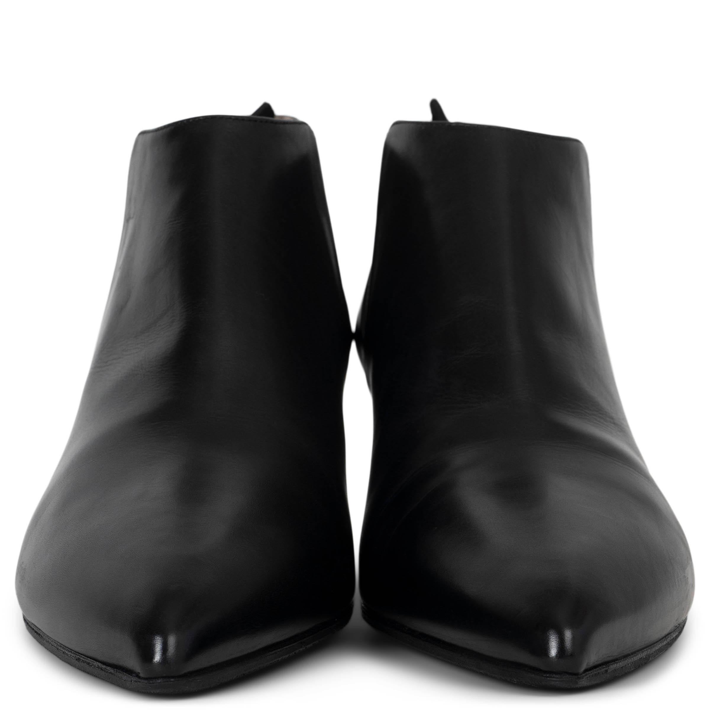 These 100% authentic Prada chelsea-style ankle boots are crafted from smooth black leather, featuring a sleek pointed toe for a modern and sophisticated look. Perfectly blending timeless design with contemporary edge, these boots are a versatile