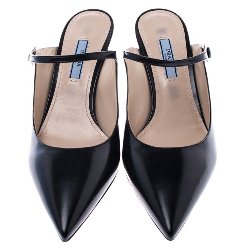 These mules by Prada will make you look confident and stylish. Crafted from leather, they come in a classic black color. They feature a sophisticated silhouette with pointed toes and a leather strap with button closure. They sit on 7.5 cm heels and