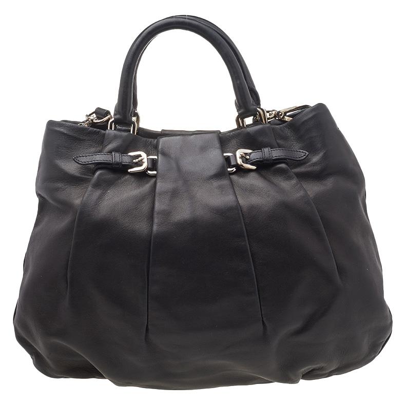 A Prada handbag should definitely be a part of your wardrobe. Crafted from leather, this piece is sure to enhance your casual or work look. It has two top handles, a shoulder strap, polished hardware, and a spacious interior.