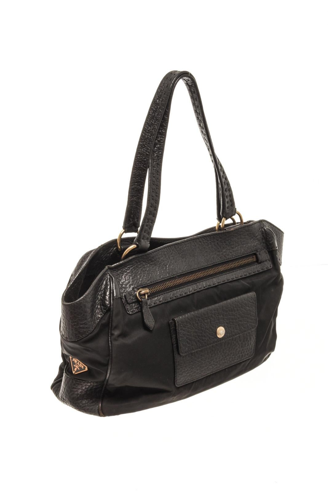 Prada Black Leather Shoulder Bag with shoulder strap, 2 exterior zipper pocket and snap pocket, Prada fabric lining, interior zipper pocket, snap pocket, gold tone hardware and magnetic closure.

86786MSC