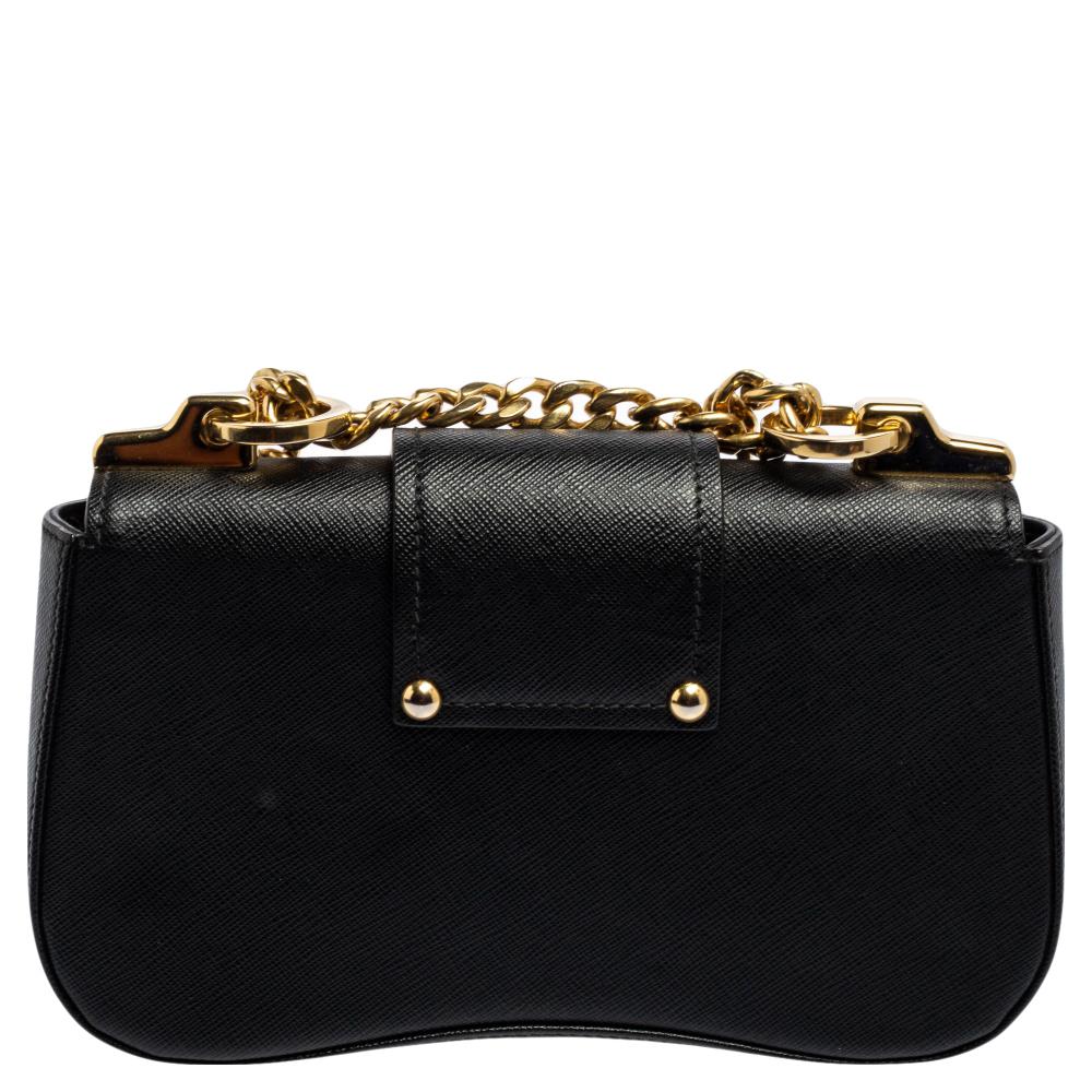 The House of Prada is known for its standard creations and designs. A fashionable fusion of grace and elegance, this Sidonie bag from Prada is truly a must-have accessory. It is made from black leather, with a gold-toned logo lettering perched on