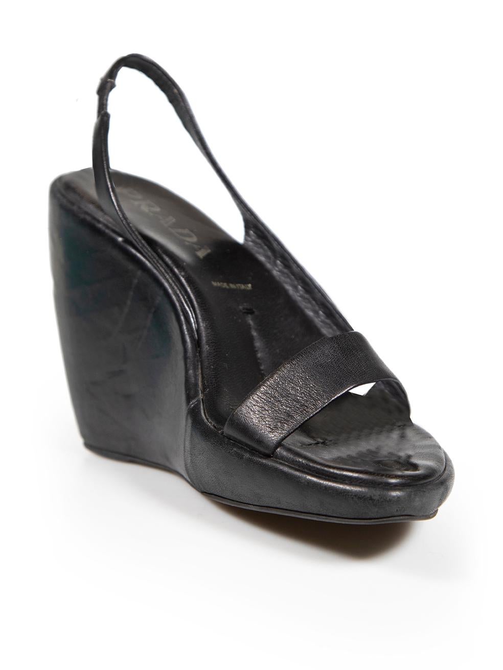 CONDITION is Good. Minor wear to wedge heels is evident. Light abrasions to the leather and some scratches to the side of the wedge heels on this used Prada designer resale item.
 
 
 
 Details
 
 
 Black
 
 Leather
 
 Wedge sandals
 
 Slingback
 
