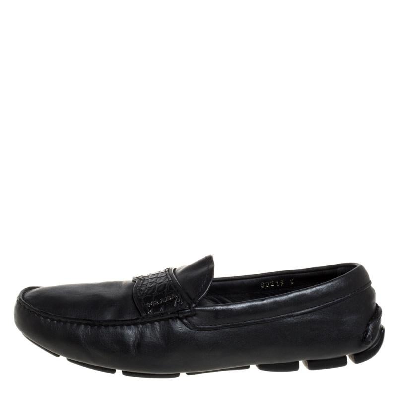 Add value to your ensemble by slipping into this pair of loafers from Prada. Made from black leather, they feature an embossed leather strap on the uppers, accented with silver-tone logo detail. Soft and plush, these shoes are sure to bring you