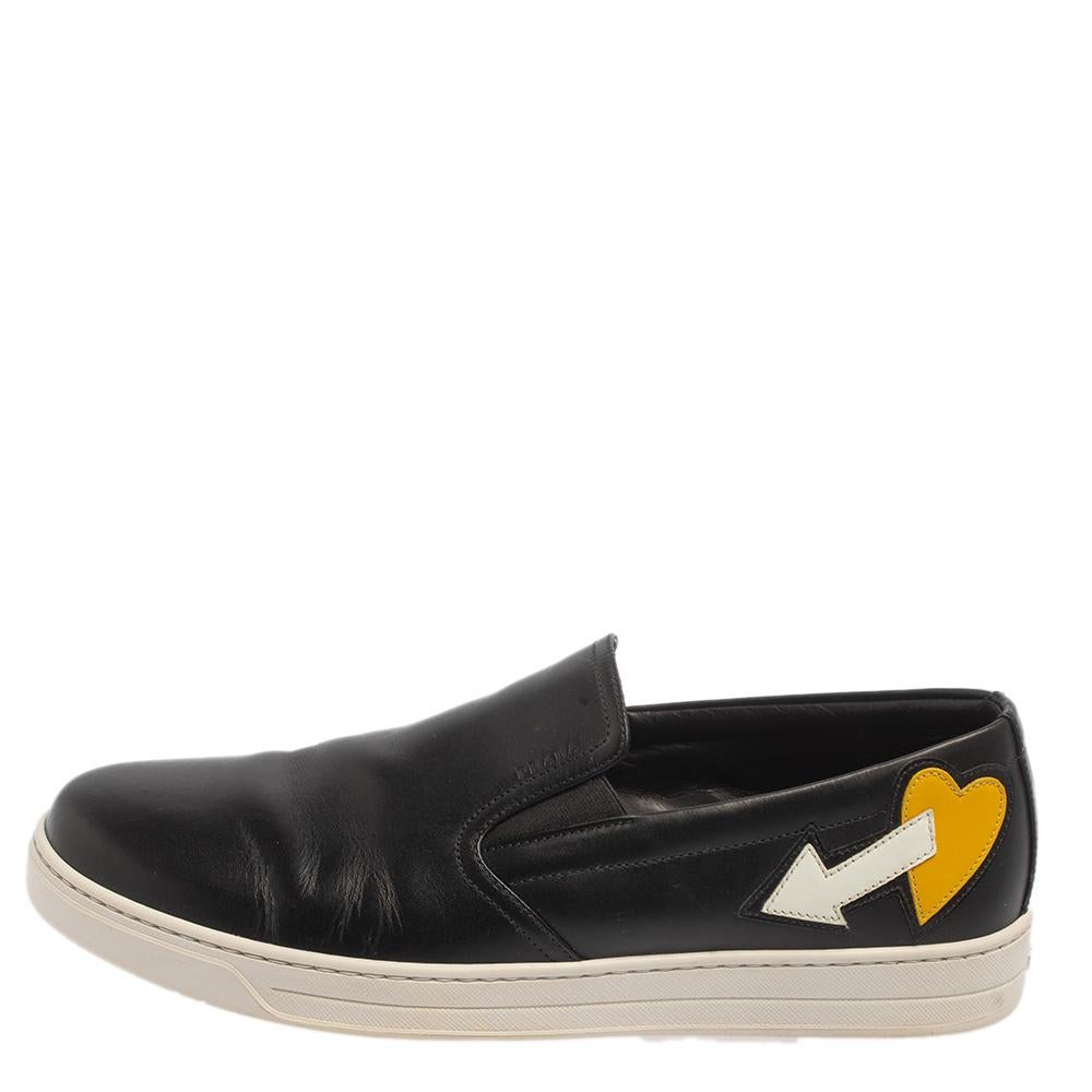 These smart and simple sneakers from Prada can assist you with casual looks. Crafted from leather in a black shade, it features heart and arrow motifs near the counters for a unique appeal.

Includes:Original Box, Original Dustbag
