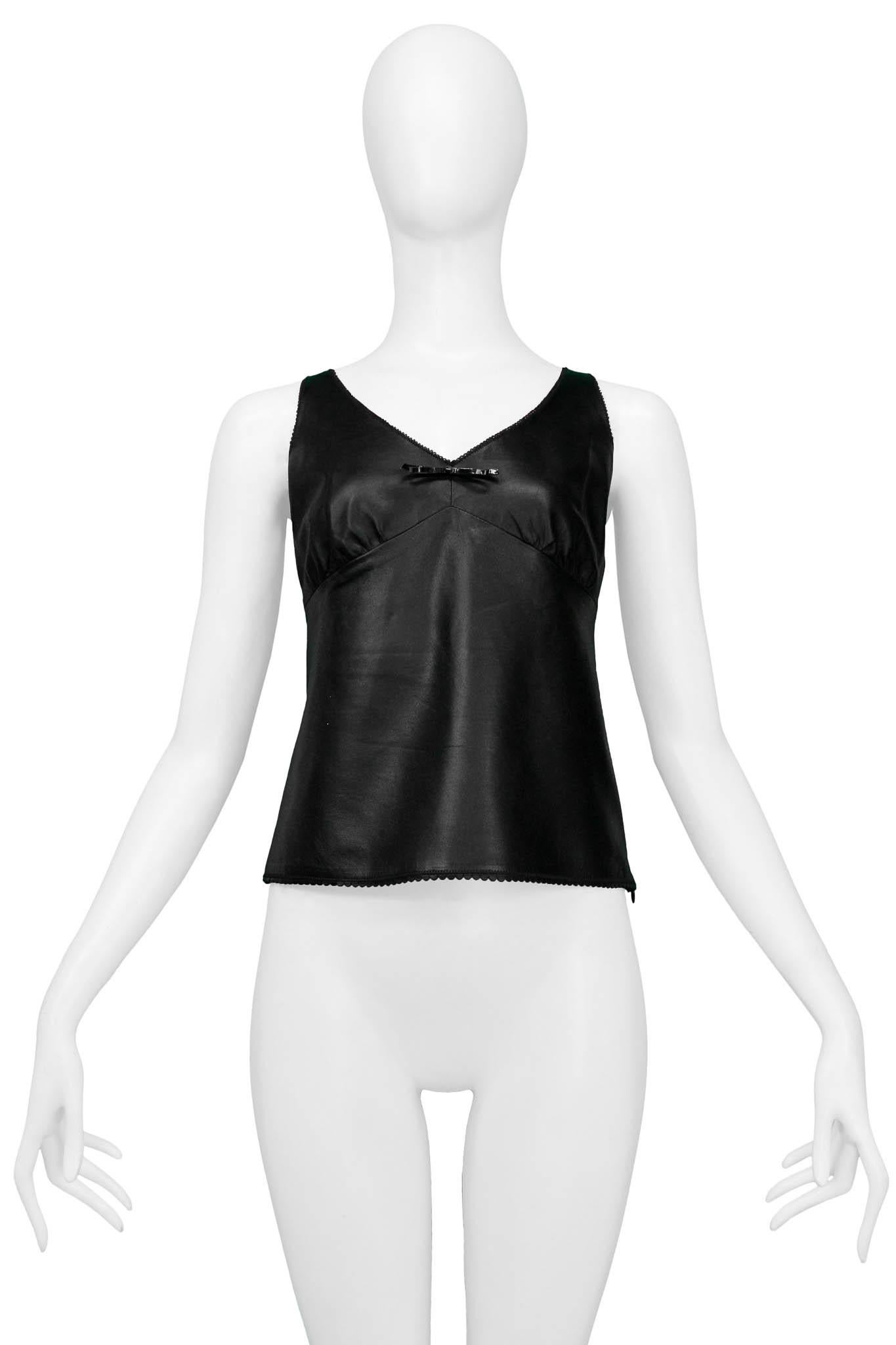 Resurrection Vintage is excited to offer a vintage Prada black leather tank top featuring slight gathering on the bust cups, a small patent-leather bow on the front, and an invisible zipper along the side seam.

Prada, Italy
Size 38
100%