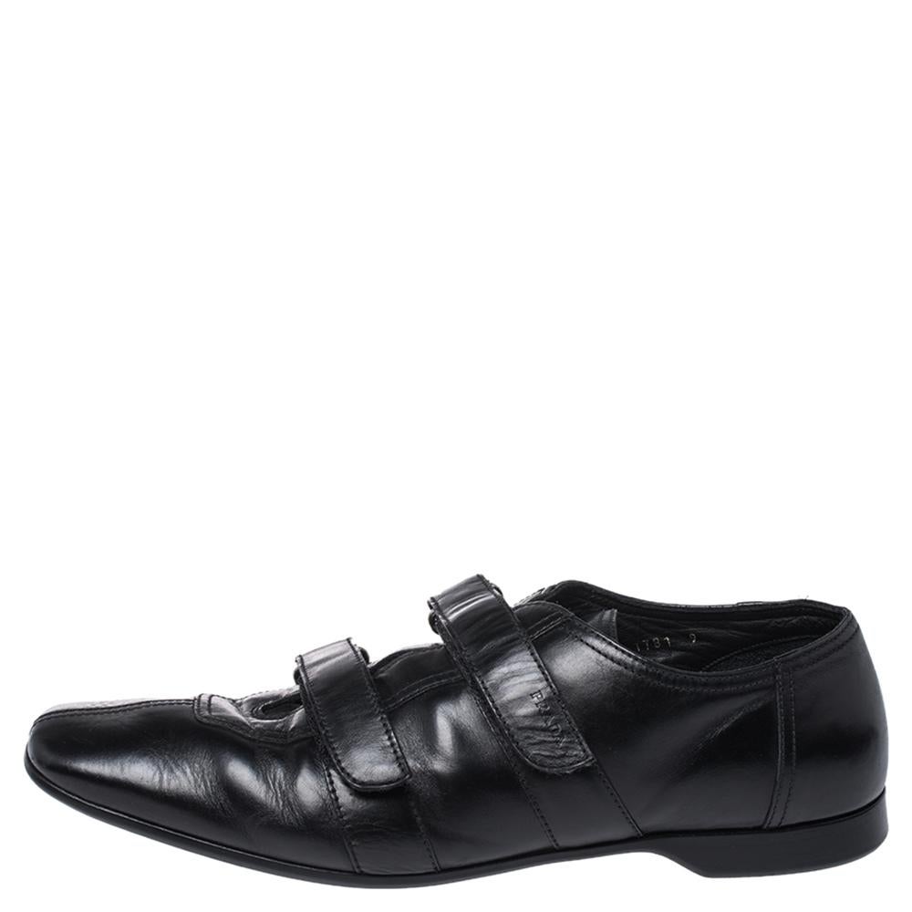 These Prada loafers are perfect for the modern man! Crafted from quality leather in Italy, they come in a versatile shade of black. They are styled with square toes, velcro straps on the uppers, silver-tone hardware, and leather insoles and soles