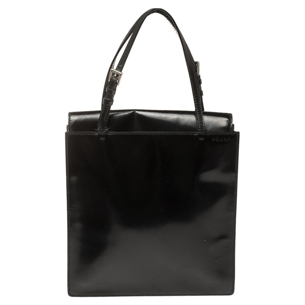 Elevating your look with a vintage design is this tote from Prada. This bag in black has been meticulously crafted from leather and equipped with a spacious satin interior that can easily hold all your essentials. Held up by two leather handles,