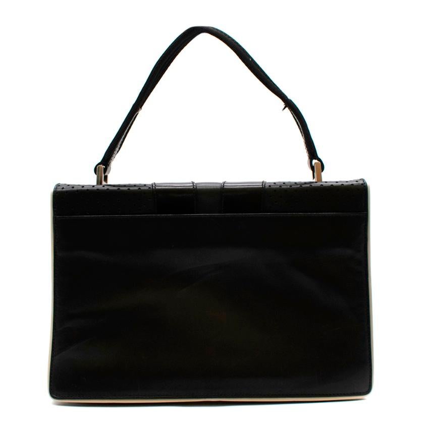 Prada Black Leather Vintage Small Top Handle Bag

- Made of soft leather 
- Iconic Prada motifs to the front 
- Branded hardware 
- Silver tone hardware
- Contrasting piping  
- Top handle 
- Interior divided into 2 sections
- Magnetic fastening to
